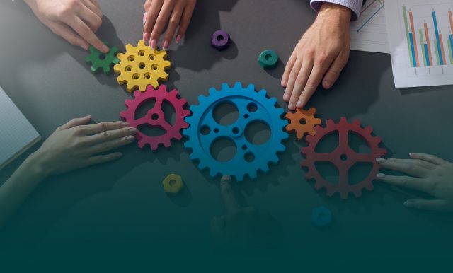 on the image people assembling gears into a single mechanism