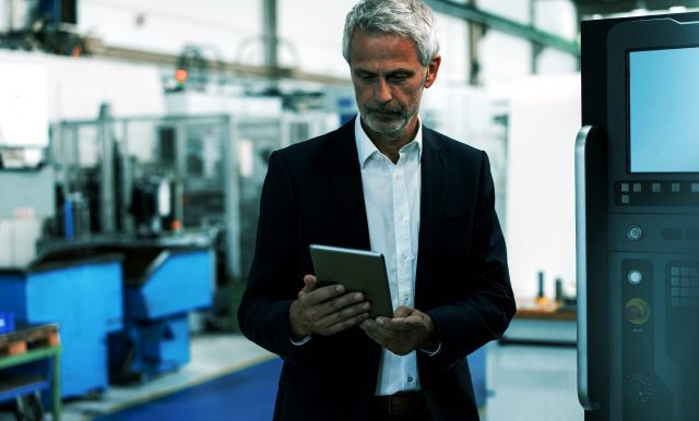Man looking at tablet in office